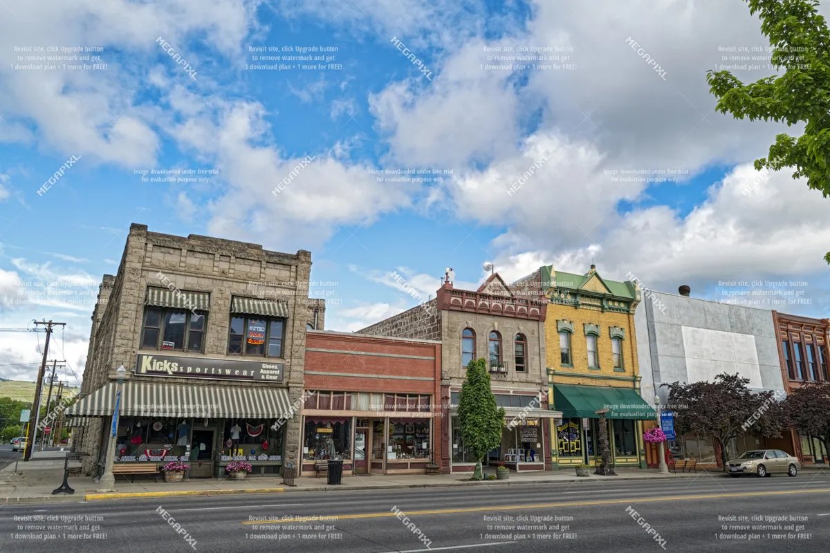 This image captures the vibrant exterior of the Kicks Sportswear store, with colorful storefronts and detailed architectural elements along a busy downtown street. The scene is lively, hinting at the variety of shopping and dining options available in the historic district.