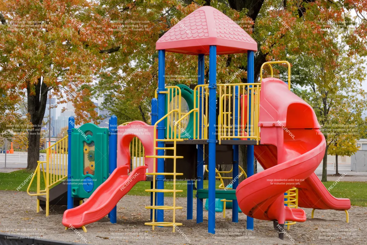 A cheerful playground scene featuring colorful slides, climbing structures, and playground equipment, with children playing and families gathered nearby. The background includes picnic areas and green space for additional outdoor activities.