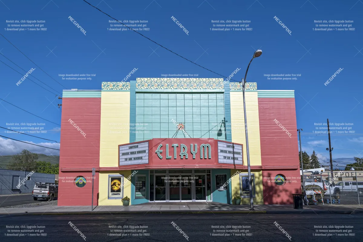 This photo showcases a classic downtown facade with a retro marquee and distinctive architectural details, evoking the charm and history of the area. The scene suggests community events, film screenings, and gatherings.